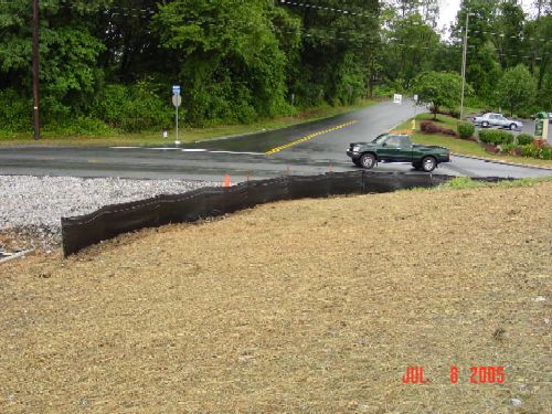 Rock construction entrance shown with silt fence and a disturbed slope with stabilization BMP